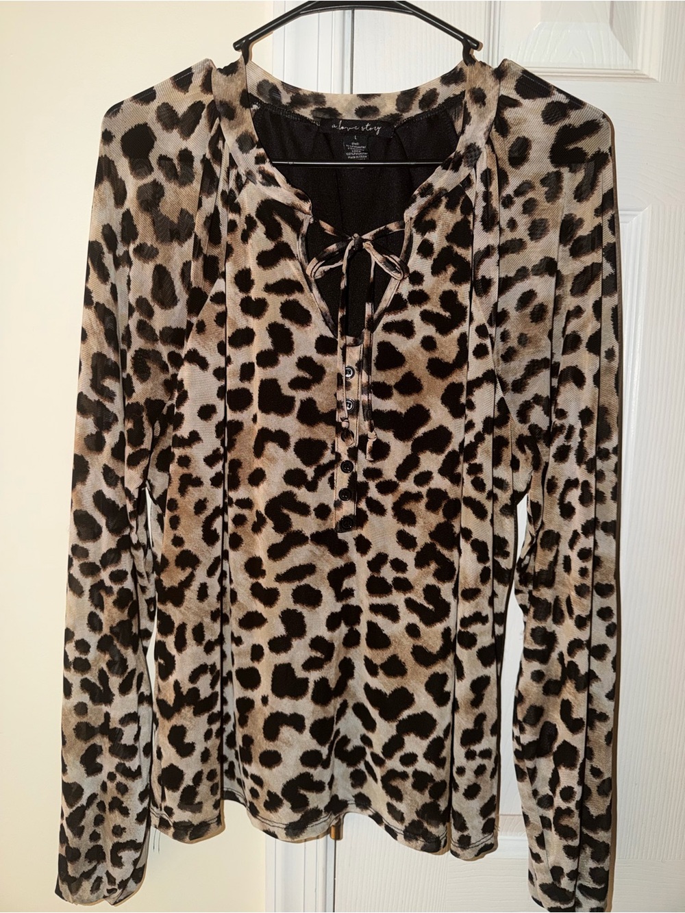 beige and black leopard print blouse with tie and buttons